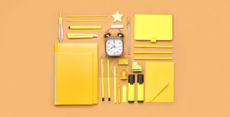 Photo for Set of yellow school supplies with alarm clock on brown background - Royalty Free Image