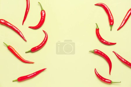 Photo for Fresh hot chili peppers on pale yellow background - Royalty Free Image