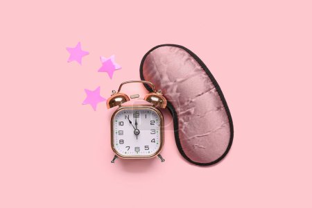 Photo for Sleeping masks, alarm clock and stars on pink background - Royalty Free Image