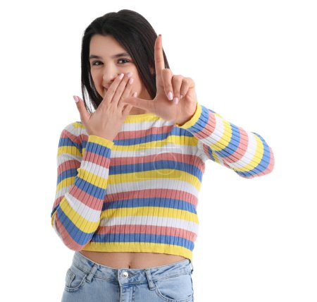 Photo for Young woman showing loser gesture on white background - Royalty Free Image
