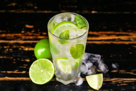 Photo for Glass of tasty mojito on dark wooden background - Royalty Free Image