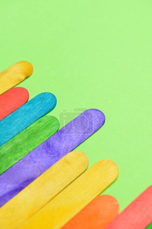 Photo for Colorful ice cream sticks on green background - Royalty Free Image