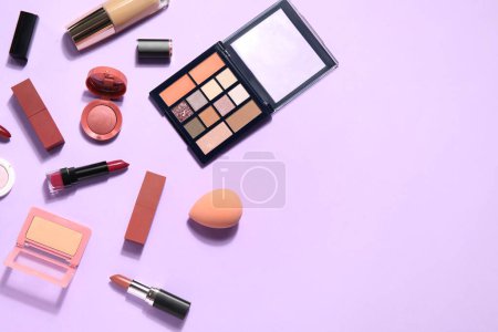 Photo for Decorative cosmetics with lipsticks and sponge on lilac background - Royalty Free Image