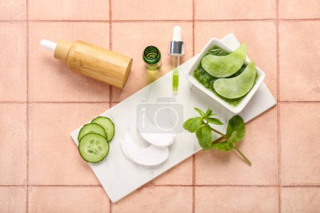 Photo for Cotton under-eye patches with cucumber slices and materials on beige tile background - Royalty Free Image