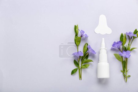 Photo for Bottle of drops with paper nose and flowers on light background. Seasonal allergy concept - Royalty Free Image
