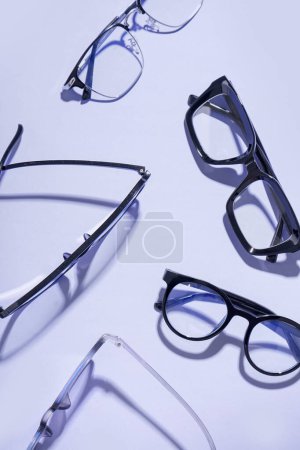 Photo for Different new eyeglasses on pale purple background - Royalty Free Image