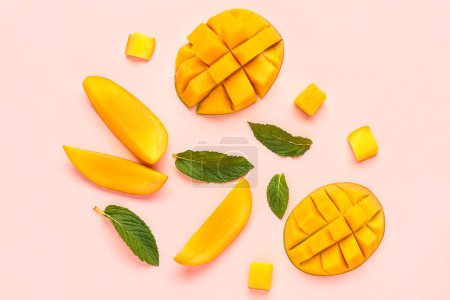 Fresh cut mangoes on light pink background