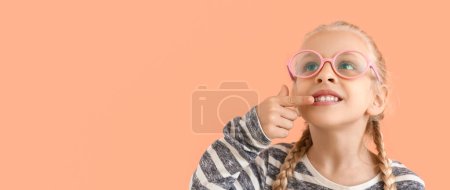 Little girl with healthy teeth on color background with space for text