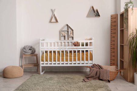 Photo for Interior of children's bedroom with crib, shelves and toys - Royalty Free Image