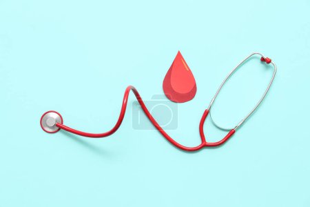Photo for Paper blood drop with stethoscope on blue background. World Donor Day - Royalty Free Image