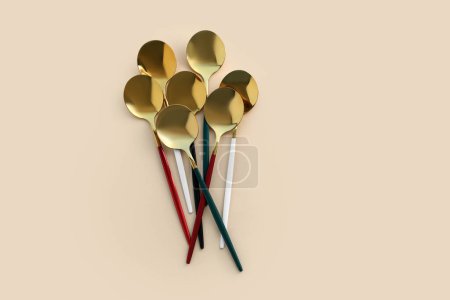 Photo for Golden spoons on beige background - Royalty Free Image