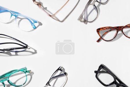 Frame made of many different stylish eyeglasses on white background
