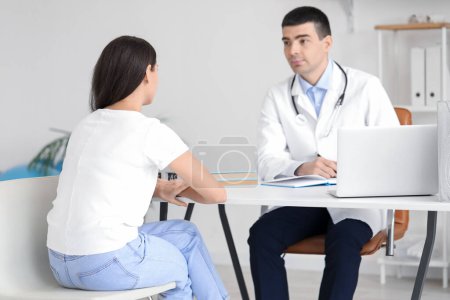 Young woman with bad posture visiting doctor in clinic