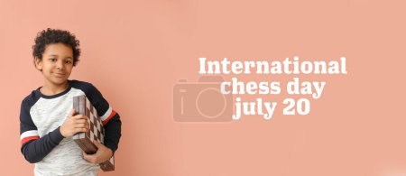 Photo for Cute African-American boy with chessboard on color background. International Chess Day - Royalty Free Image