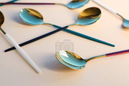 Photo for Golden spoons on beige background - Royalty Free Image