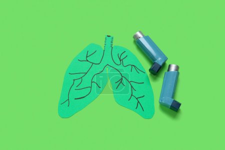Téléchargez les photos : Poumons en papier et inhalateurs d'asthme sur fond vert - en image libre de droit