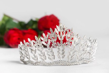 Photo for Beautiful tiara on white table, closeup. Prom concept - Royalty Free Image