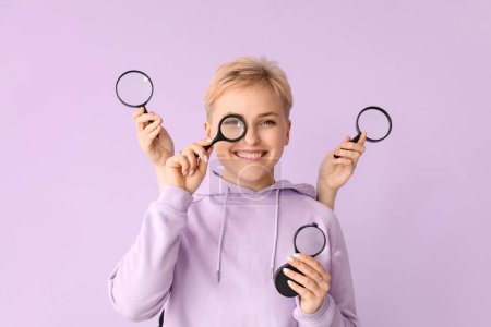Photo for Young woman and female hands with magnifiers on lilac background - Royalty Free Image