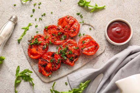 Photo for Board with tasty grilled tomatoes and green onion on grey background - Royalty Free Image
