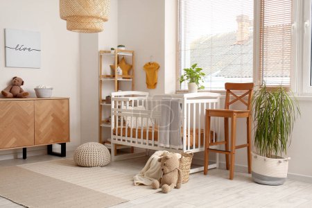 Interior of children's bedroom with wooden cabinet and bed near window