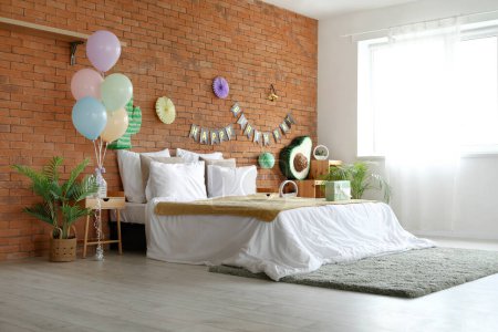 Photo for Interior of bedroom decorated for birthday party with pinata, balloons and garland - Royalty Free Image