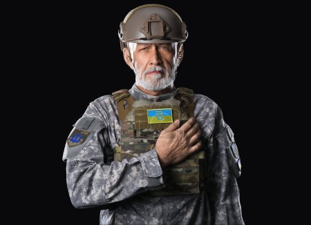 Photo for Mature soldier with Ukrainian patch on dark background - Royalty Free Image