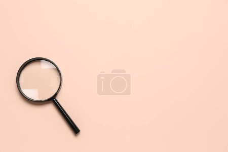 Photo for Black magnifier on pale pink background - Royalty Free Image