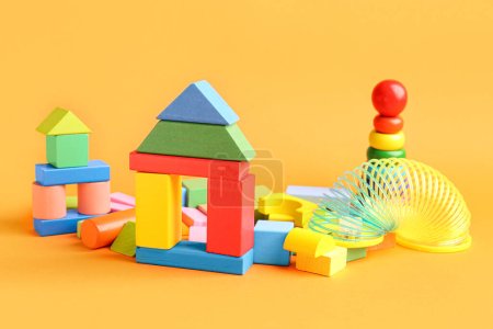 Foto de Diferentes juguetes de colores sobre fondo naranja. Celebración del Día de los Niños - Imagen libre de derechos