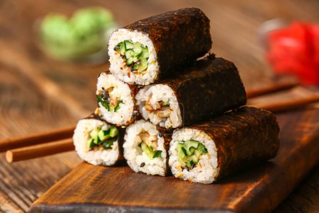 Photo for Tasty maki rolls on wooden background - Royalty Free Image