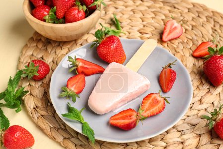 Photo for Plate with sweet strawberry ice-cream popsicle and bowl of berries on yellow background - Royalty Free Image