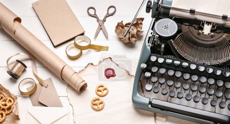 Téléchargez les photos : Machine à écrire vintage, parchemins, craquelins, rubans et ciseaux sur table en bois blanc - en image libre de droit