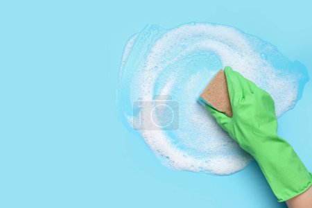 Photo for Woman with sponge and foam cleaning on blue background - Royalty Free Image