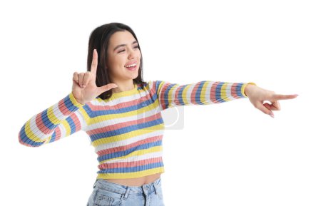 Photo for Young woman showing loser gesture on white background - Royalty Free Image