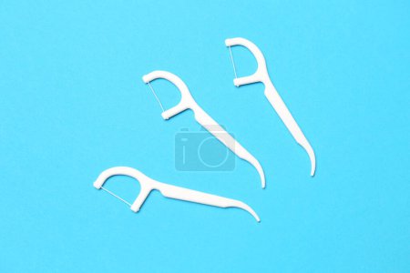 Photo for Floss toothpicks on blue background - Royalty Free Image