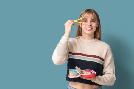 Photo for Female student with pencil case and pair of scissors on blue background - Royalty Free Image
