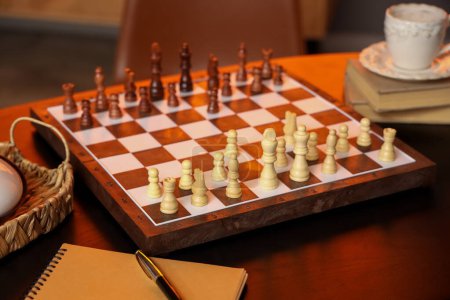 Photo for Game board with chess pieces on table in room, closeup - Royalty Free Image