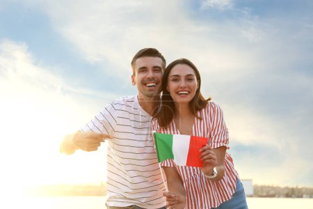 Photo for Happy young couple with Italian flag outdoors - Royalty Free Image
