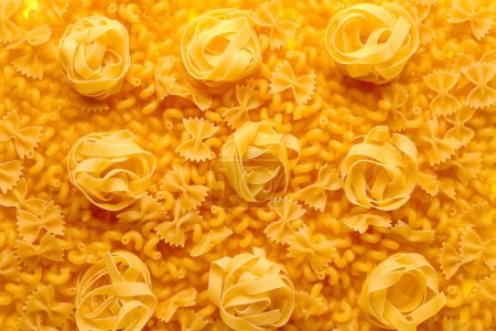 Photo for Raw fettuccine, farfale and cavatappi pasta as background, closeup - Royalty Free Image