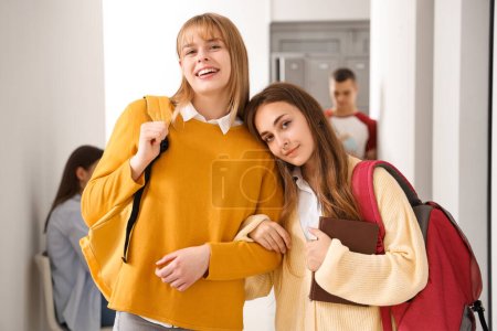 Photo for Teenage girls hugging at school - Royalty Free Image