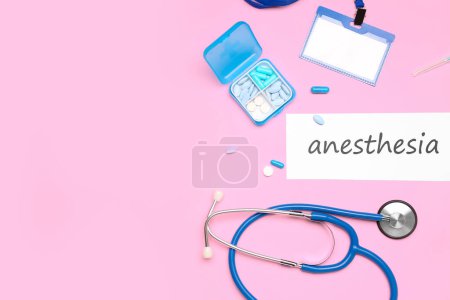 Paper with word ANESTHESIA and medical supplies on pink background