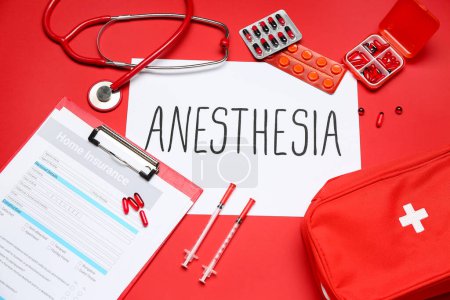 Photo for Paper with word ANESTHESIA and medical supplies on red background - Royalty Free Image