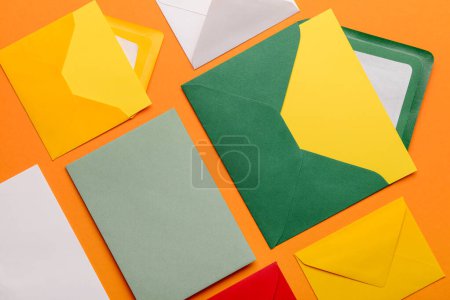 Set of different envelopes with blank cards on color background, closeup