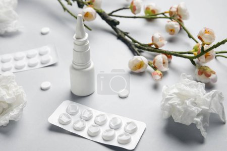 Photo for Nasal drops with pills, flowers and tissues on grey background, closeup. Seasonal allergy concept - Royalty Free Image