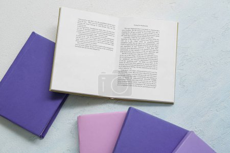 Photo for Open book on light blue table - Royalty Free Image