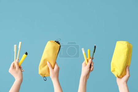 Téléchargez les photos : Female hands with school supplies on blue background - en image libre de droit