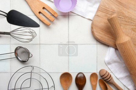 Foto de Marco hecho de diferentes utensilios de cocina sobre fondo de baldosas de luz - Imagen libre de derechos