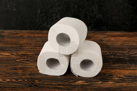 Photo for Rolls of toilet paper on wooden table - Royalty Free Image