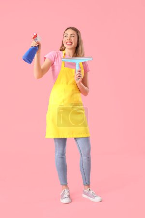 Photo for Young woman with bottle of detergent and squeegee on pink background - Royalty Free Image