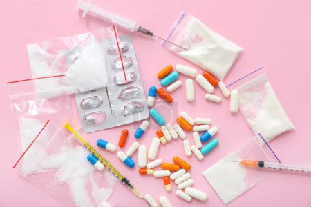 Photo for Different drugs and syringes on pink background - Royalty Free Image