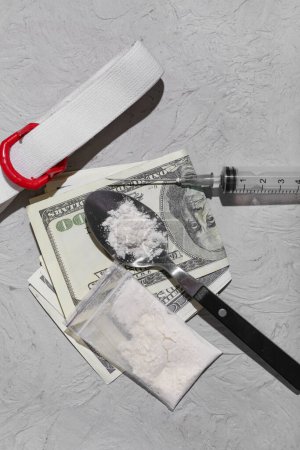 Photo for Composition with drugs, syringe, tourniquet and money on grey background - Royalty Free Image